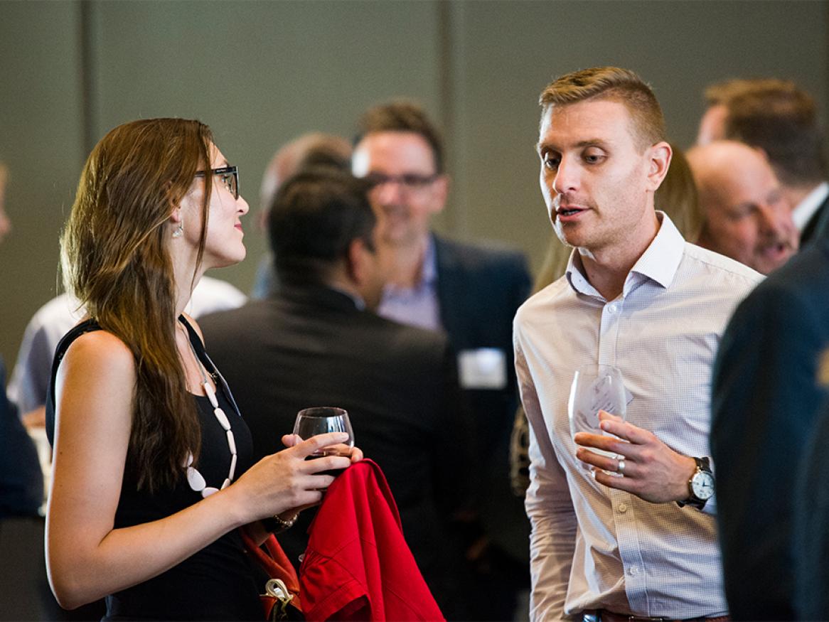 A photo of two people chatting at an industry event