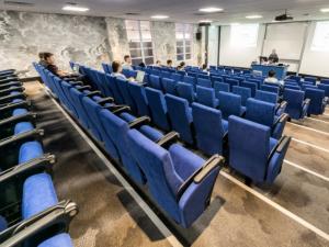 Photo of seminar room with bright blue seats in Barr Smith South