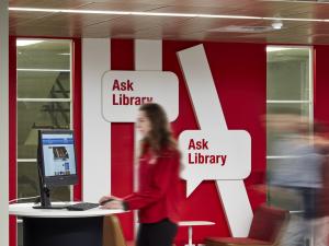 Photo of an Ask Library staff member at the service area on Level 1 of the Barr Smith Library.