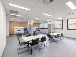 Teaching room with table and hospital bed