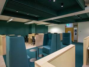 HDR Student Hub - booths with round tables and blue seating