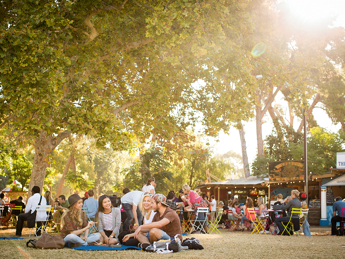 Living in Adelaide - Image at the Fringe Festival, group of people sitting on the grass having fun