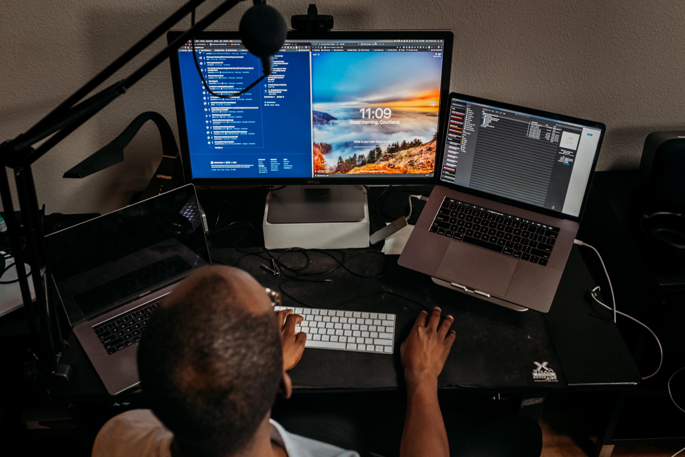 A man and 3 screens