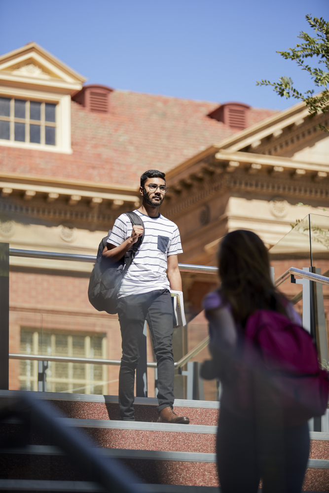 Student walking past the library