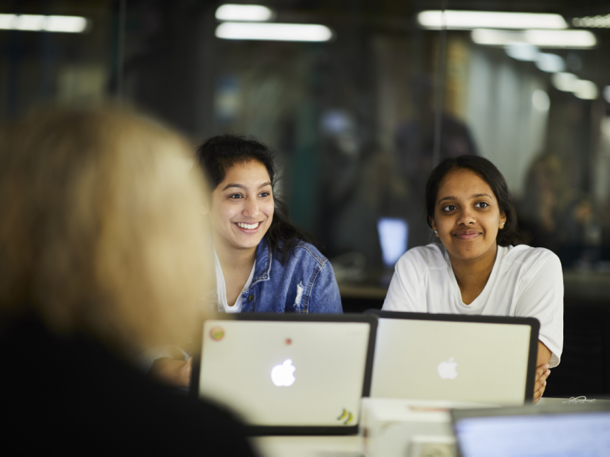 Students smiling on computers