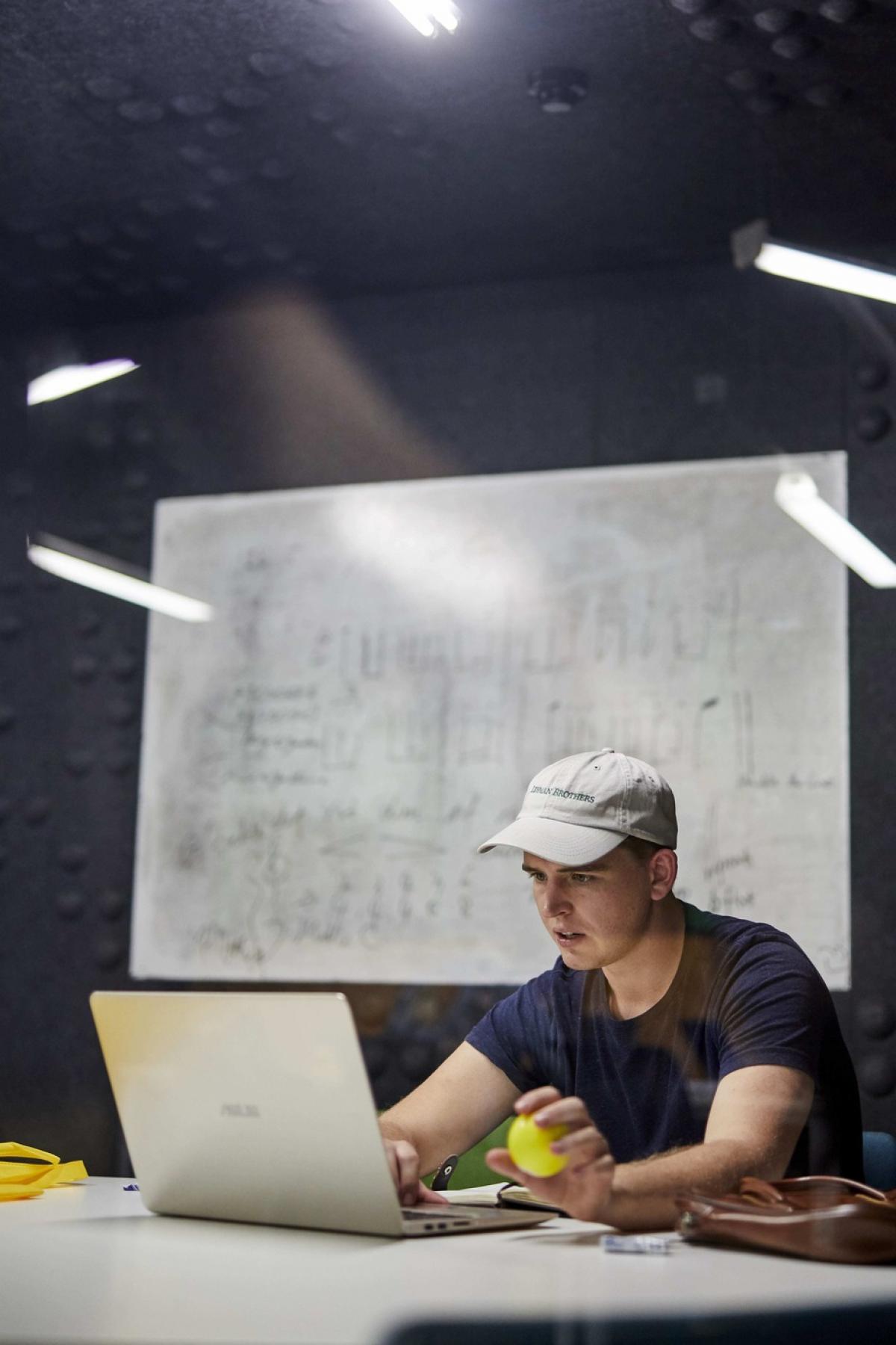 student working on a laptop in a study space