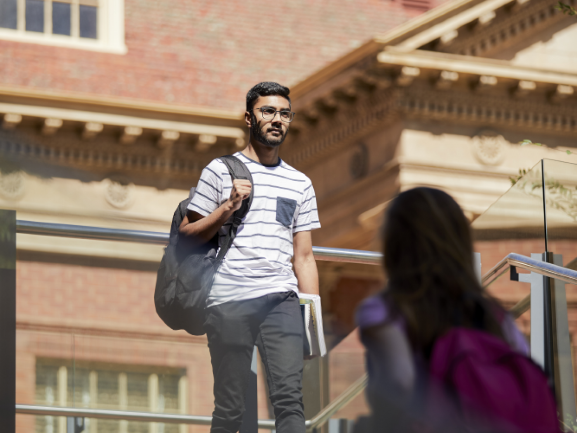 Student walking past the library