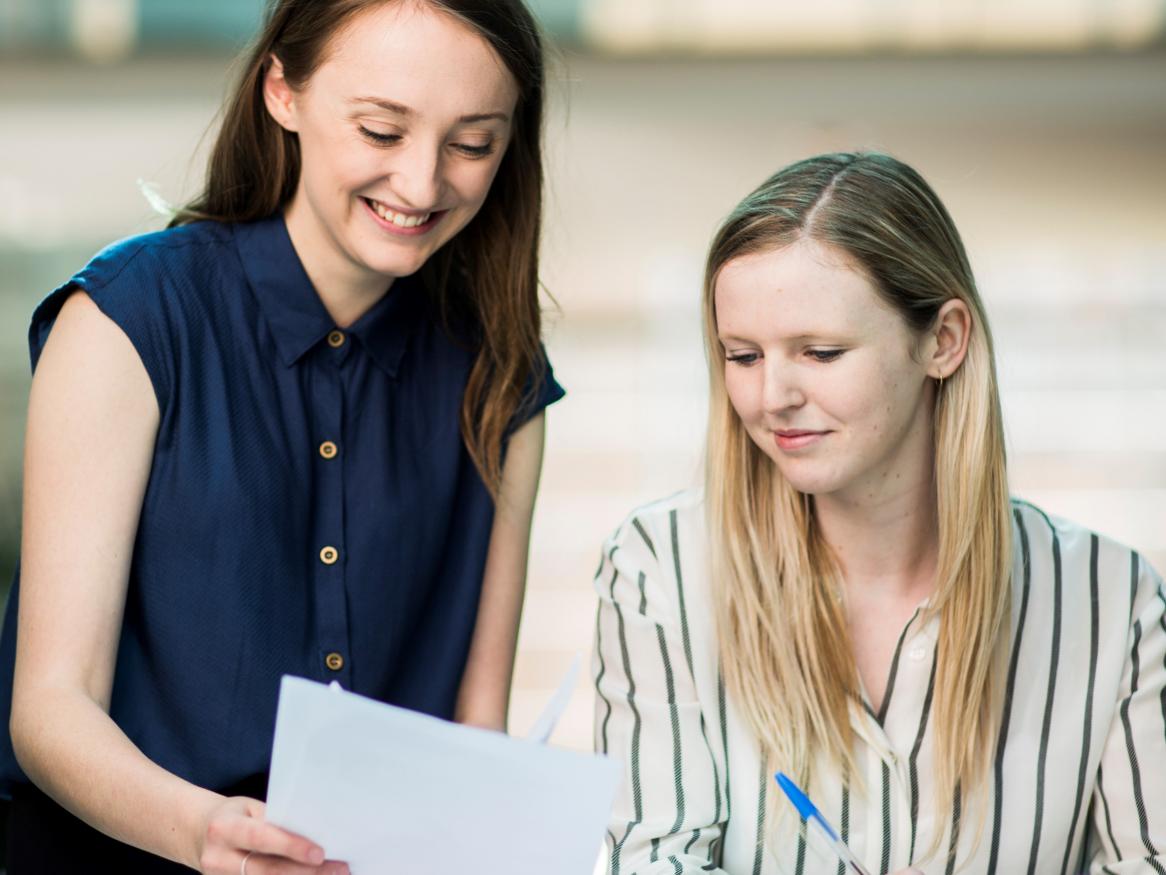 two students read a document