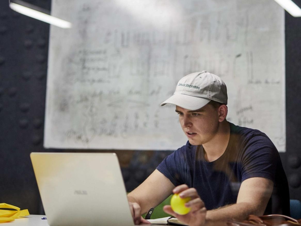 student working on a laptop in a study space