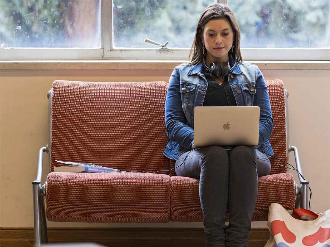 Community member on laptop in the library