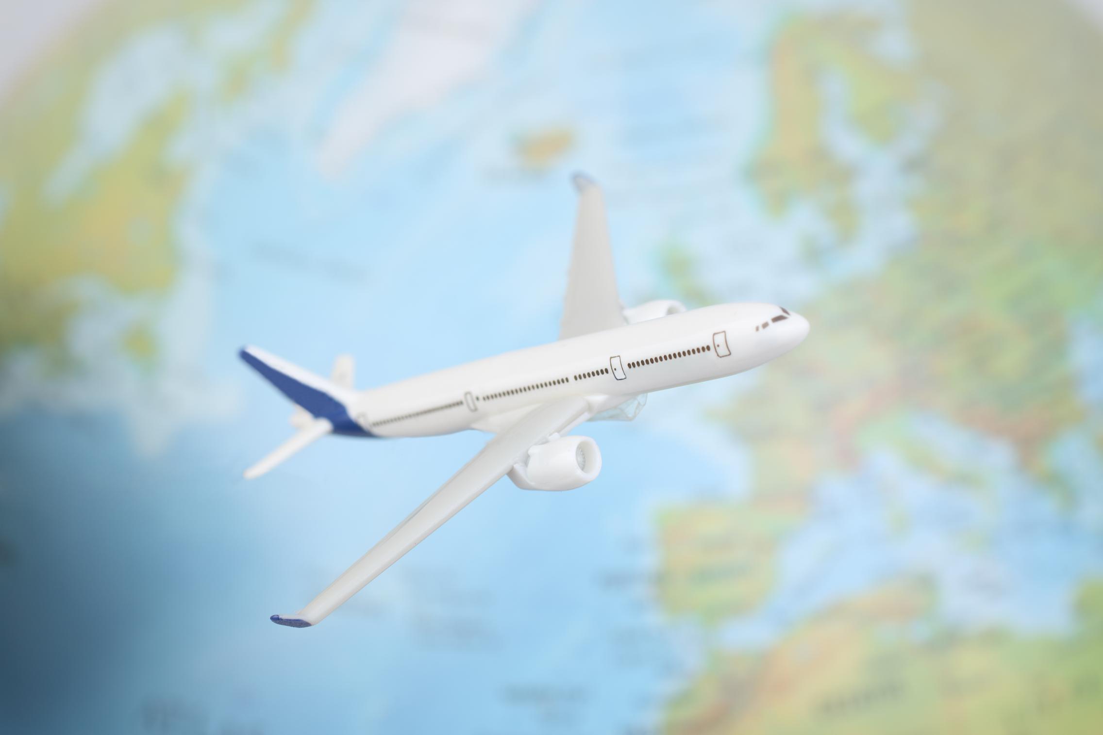 Image of an airplane flying over what looks like England