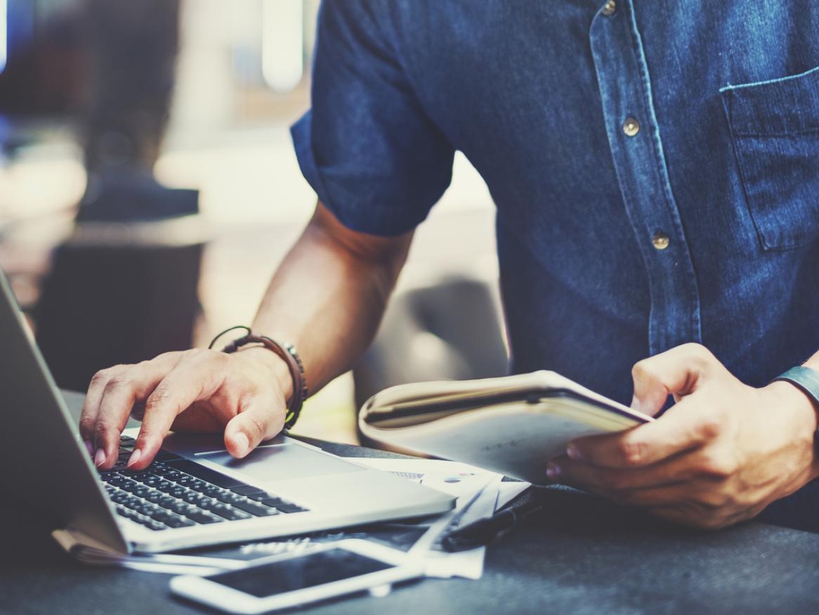 Photo of a male student looking at an eBook on his laptop