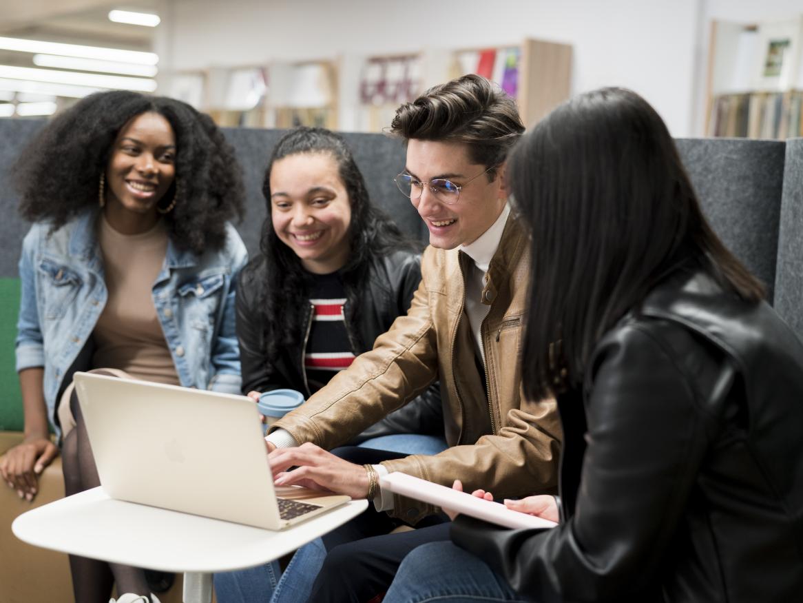 Photo of students looking at laptop