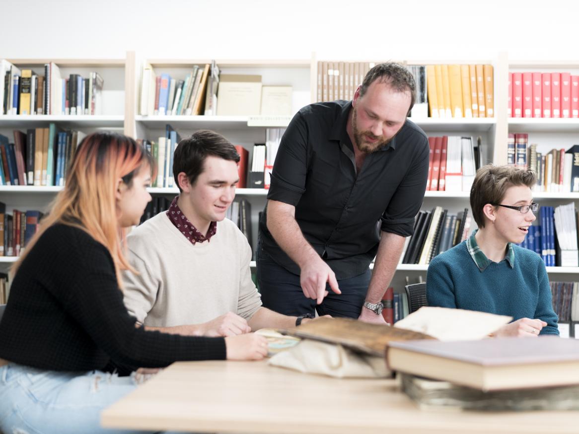 Photo of a library staff member working with a group of students