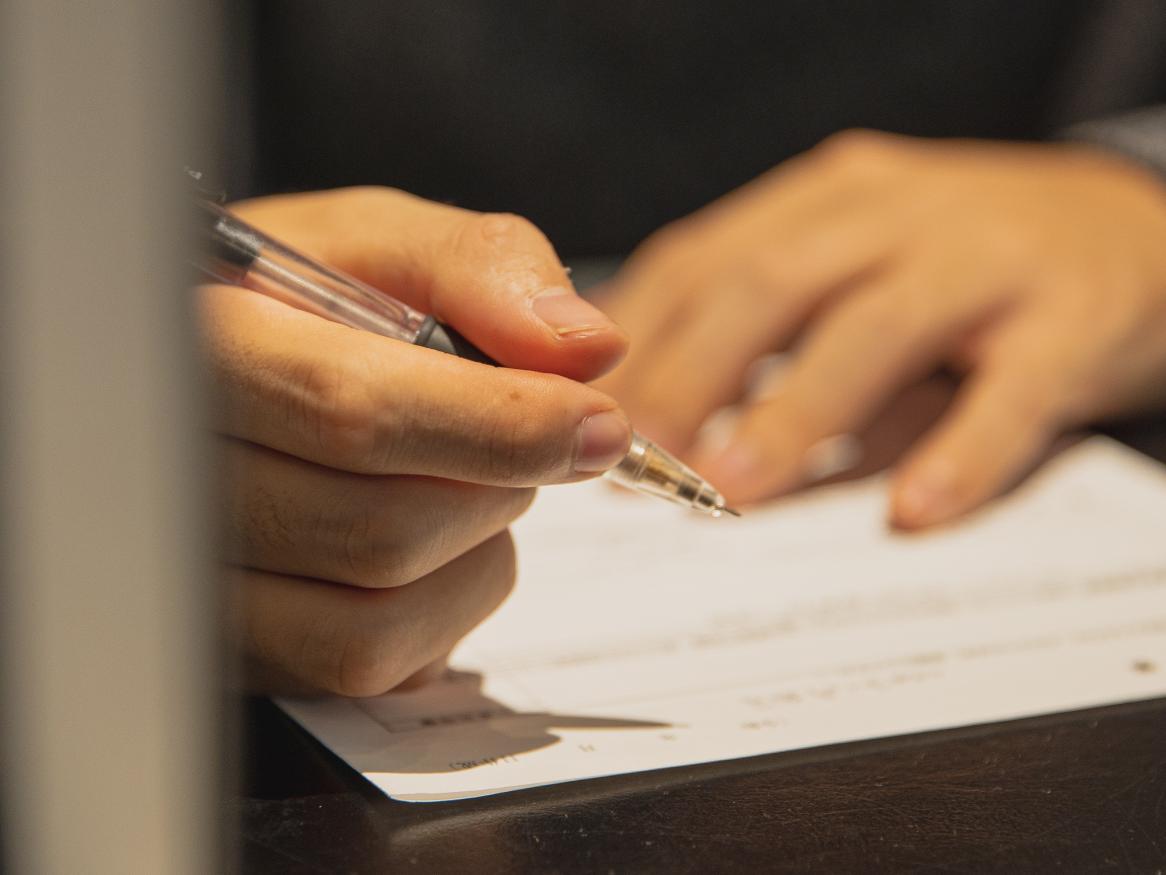 Person editing writing on paper