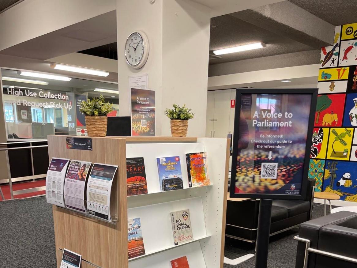 A book display with leaflets on one side