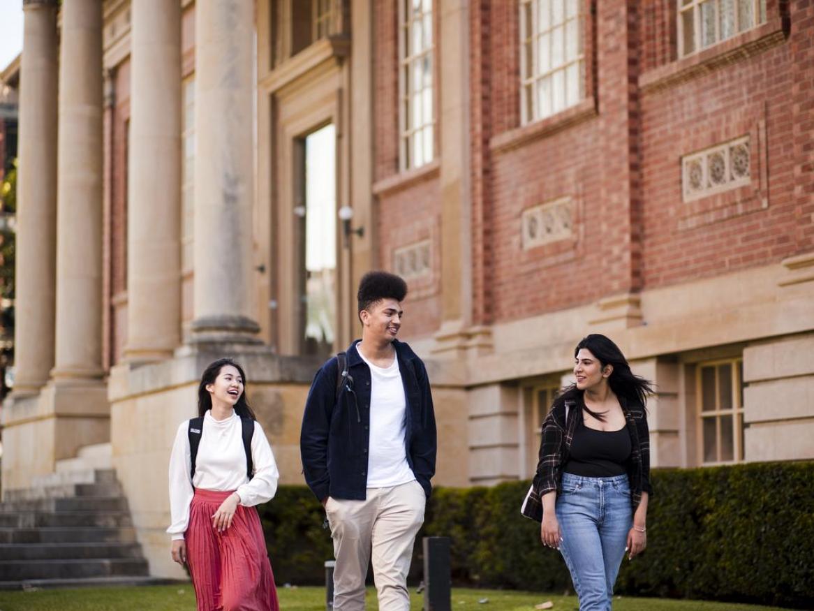 Students in front of the Barr Smith Library, walking and talking