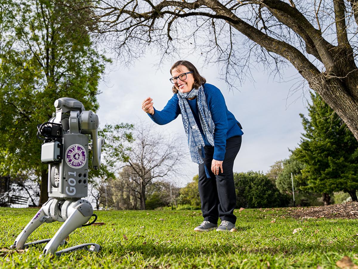 Susan Hazel plays with Kadli, AIML’s robot dog