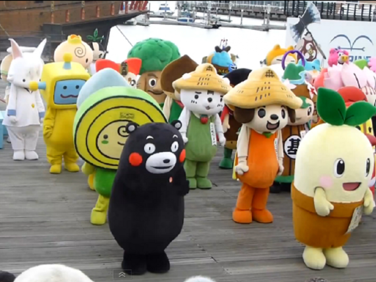 A photo of a crowd of mascot costumes. You can see a bear, and a plant in a pot, a unicorn, a robot and many others. http://www.worldrecordacademy.com/mass/most_mascots_to_do_the_same_dance_Japan_breaks_Guinness_world_record_213225.html