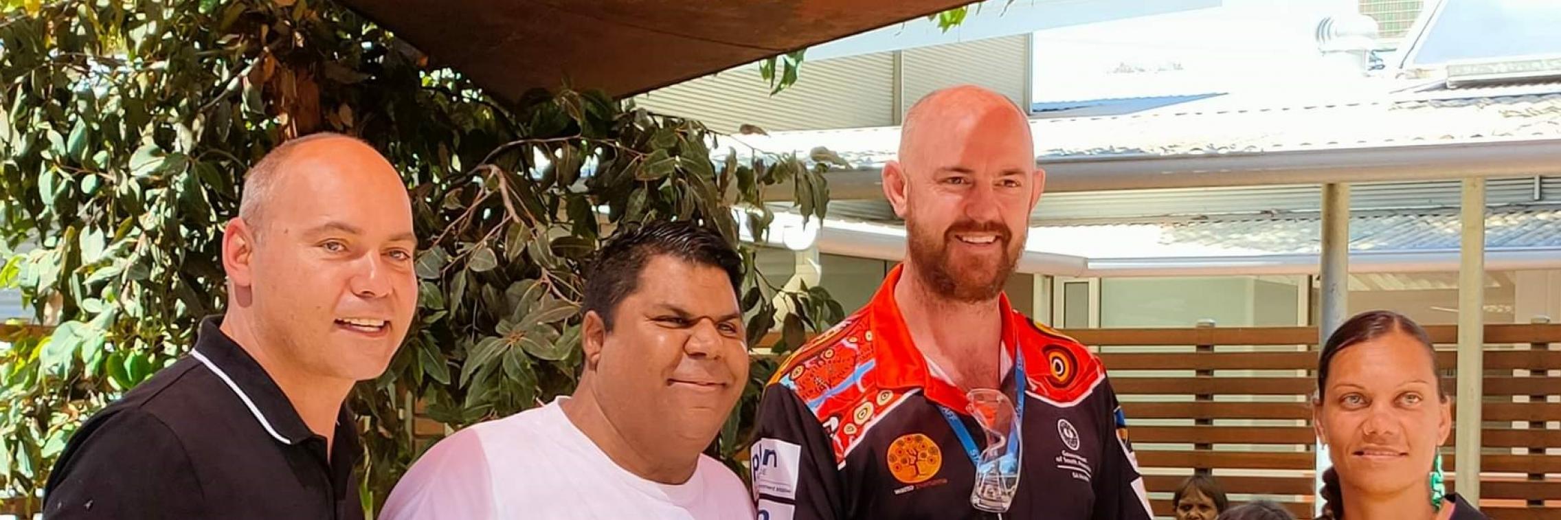 AKction Reference Group members Jared and Rhanee presenting a memorial Kidney art piece to Kanggawodli Aboriginal Hostel and dialysis service at the launch of the Cultural Bias document - L to R Wade Alan, Jared Katinyeri, Kurt Towers and Rhanee Lester.