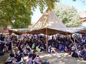 Circular tent with children sitting underneath