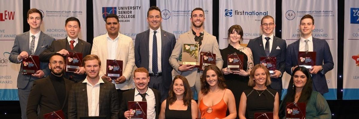 The 15 South Australian 7 News Young Achiever Awards winners hold their trophies and smile.