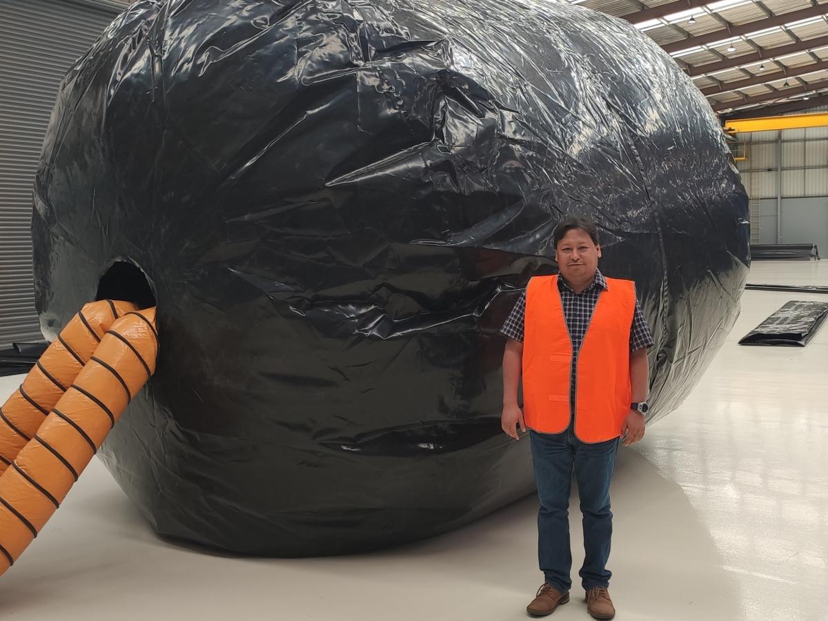 Dr Bellido Caceres in front of a geomembrane at Aquamate's facility