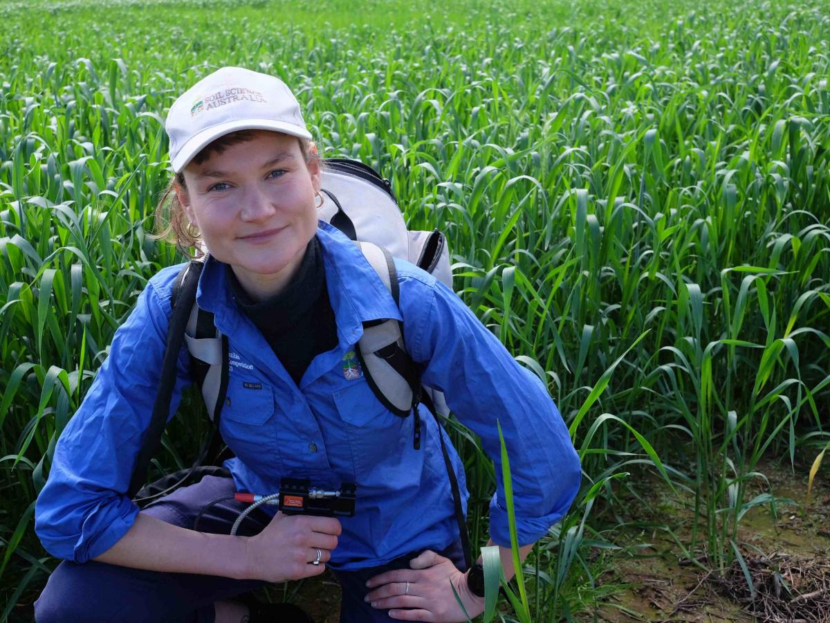 Ruby Hume taking soil measurements in the field.