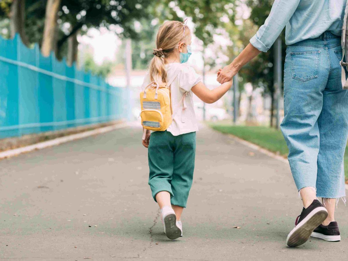 Child being walked to school by parent