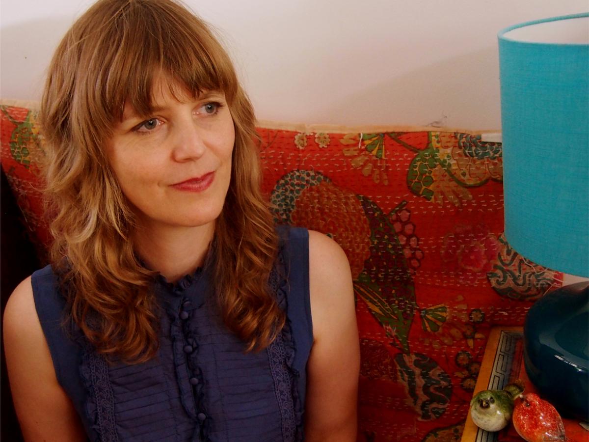 Author Molly Murn sitting on a couch