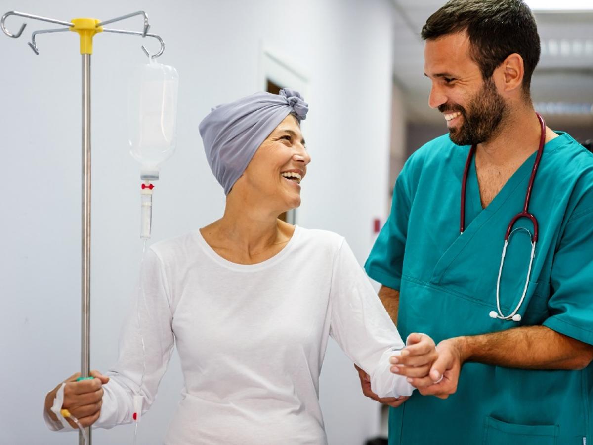 A doctor and patient smile at each other,