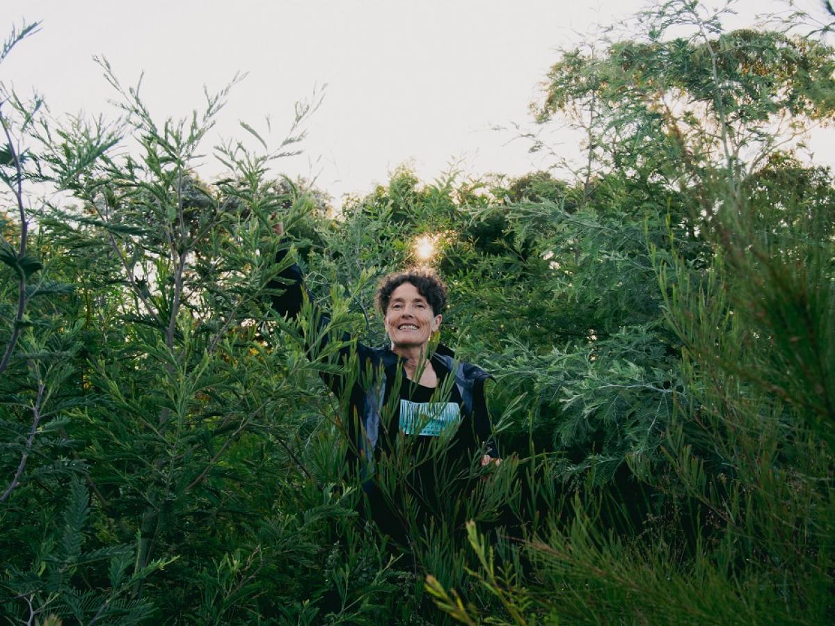 Edwina Robinson smiles amongst a mini forest in Canberra.