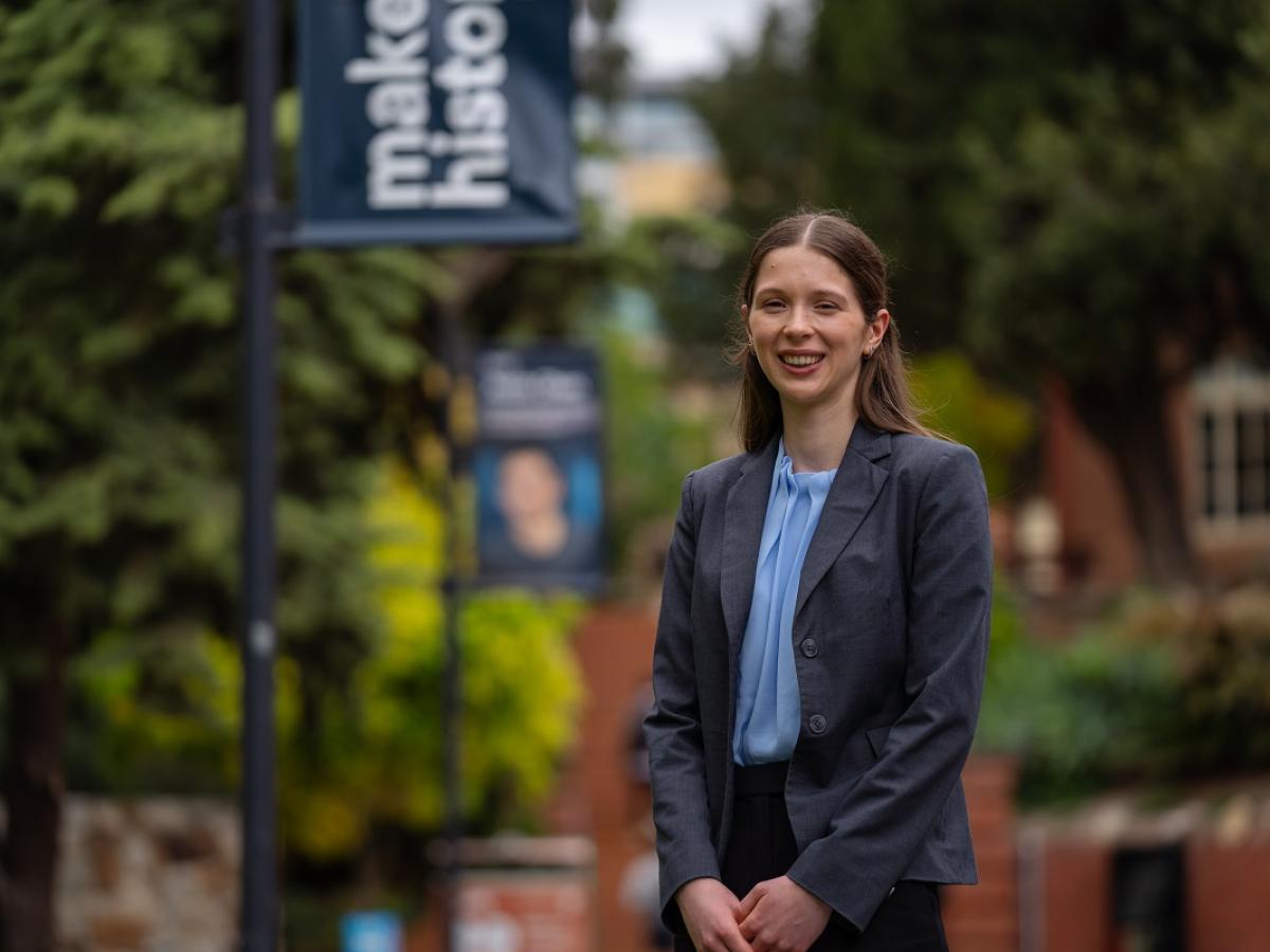 Bridget Smart stands and smiles, at the University of Adelaide campus.