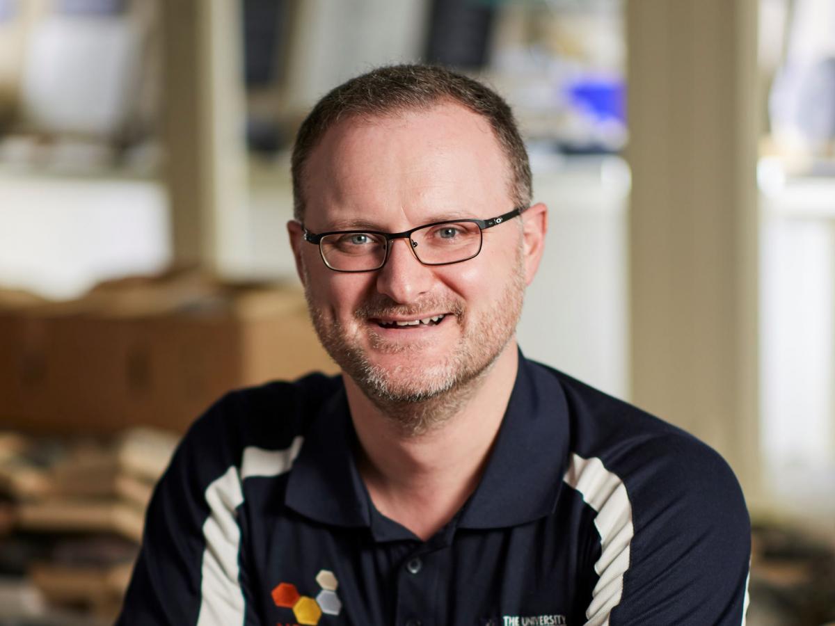 Dr Richard Lilly smiles into the camera.