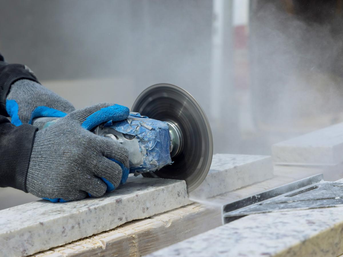 A worker cutting stone