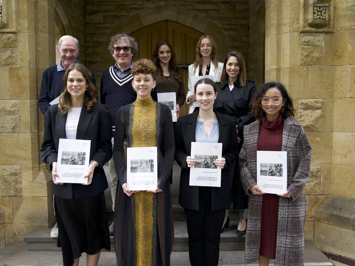 The co-authors of SALRI's Suppression Order Report stand with a copy of their work.