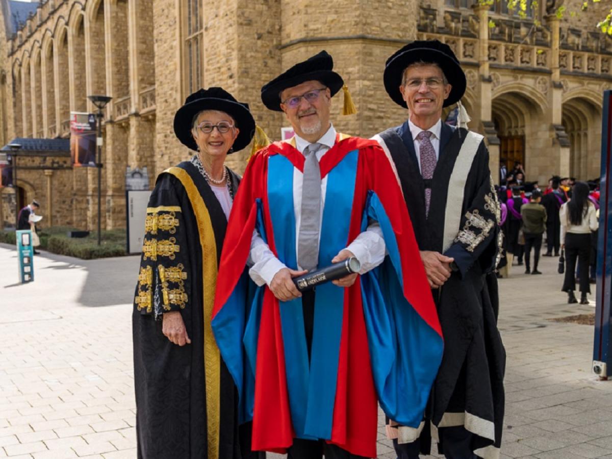 Mr Simon Hackett receives his Honorary Doctorate from Professor Peter Høj AC and the Hon Catherine Branson AC KC outside Bonython Hall.