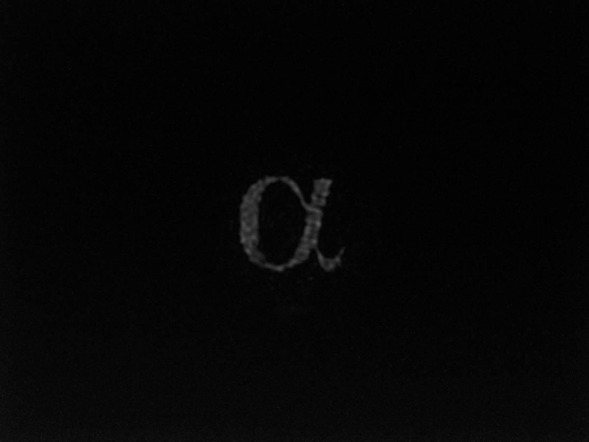 Greek letter alpha projected through the optical fibre