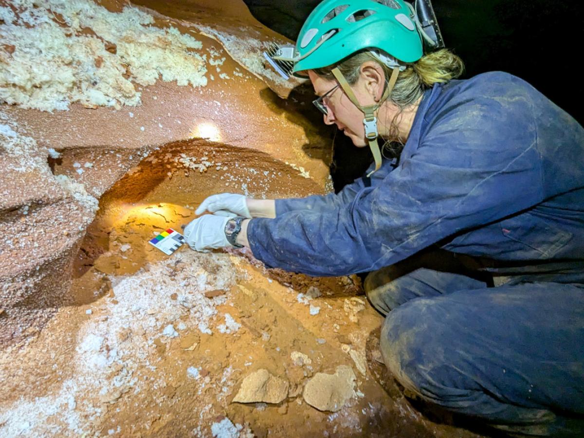 Jess Marsh surveying a cave. Credit: Steve Milner.