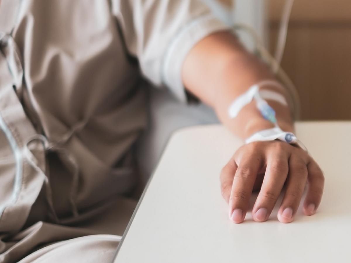 Patient's hand with cannula resting on a table