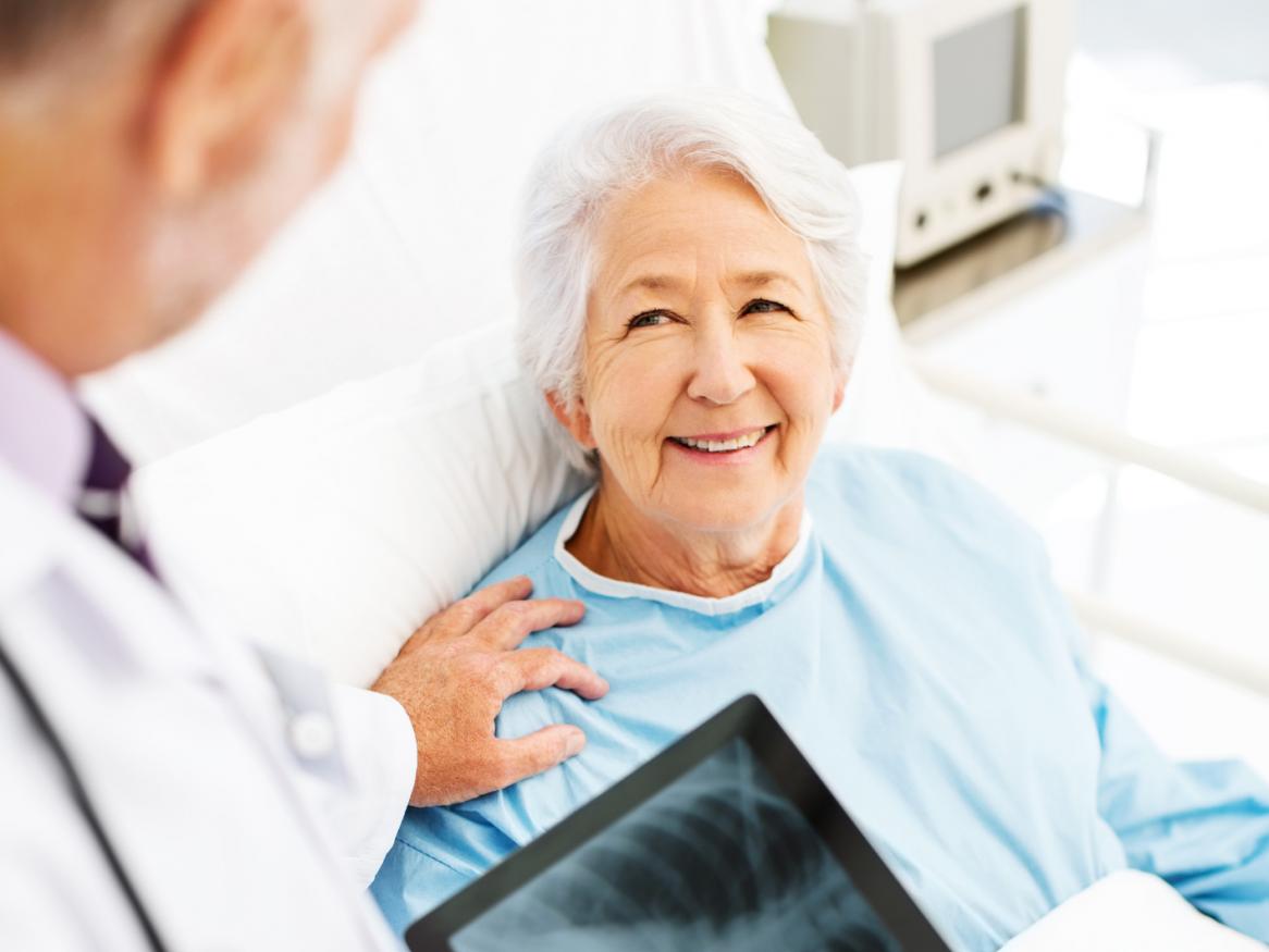 Elderly patient discussing x-ray with doctor