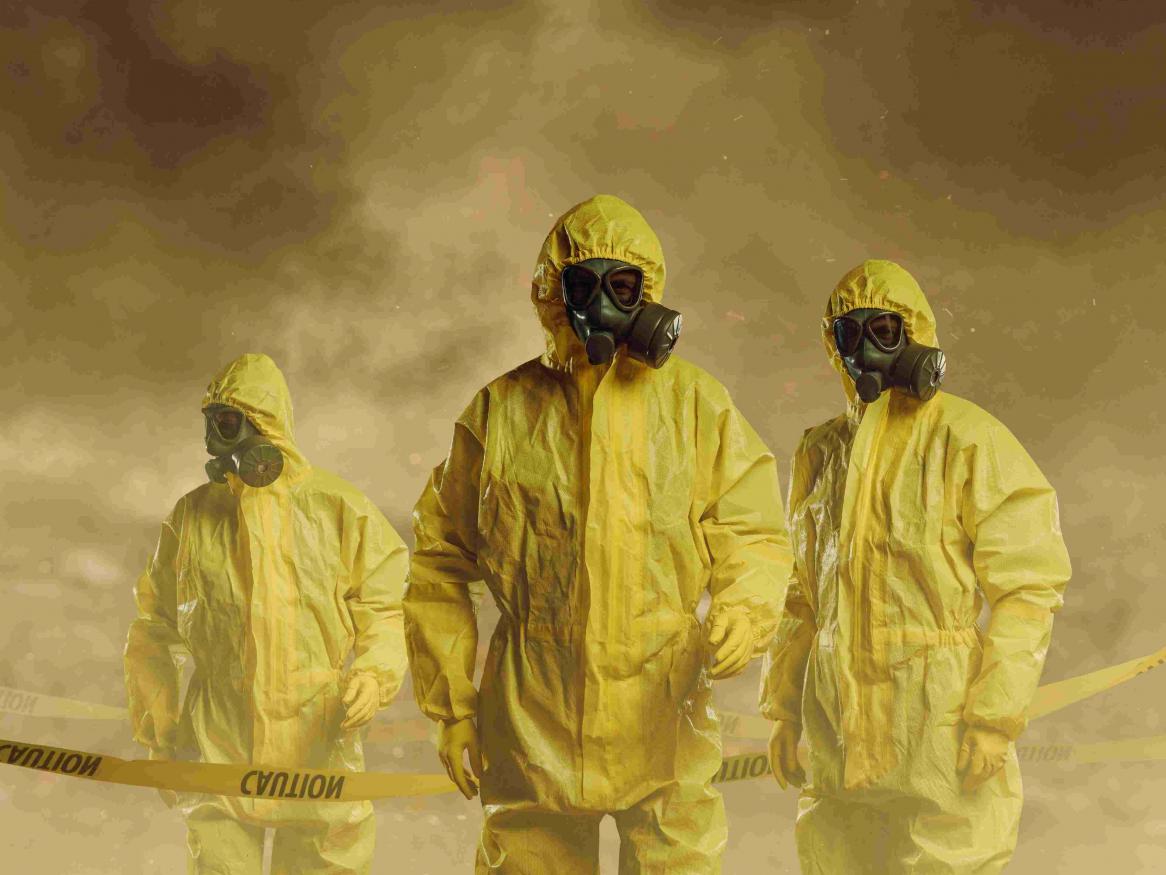 Image of People wearing protective suits as part of biosecurity measures.