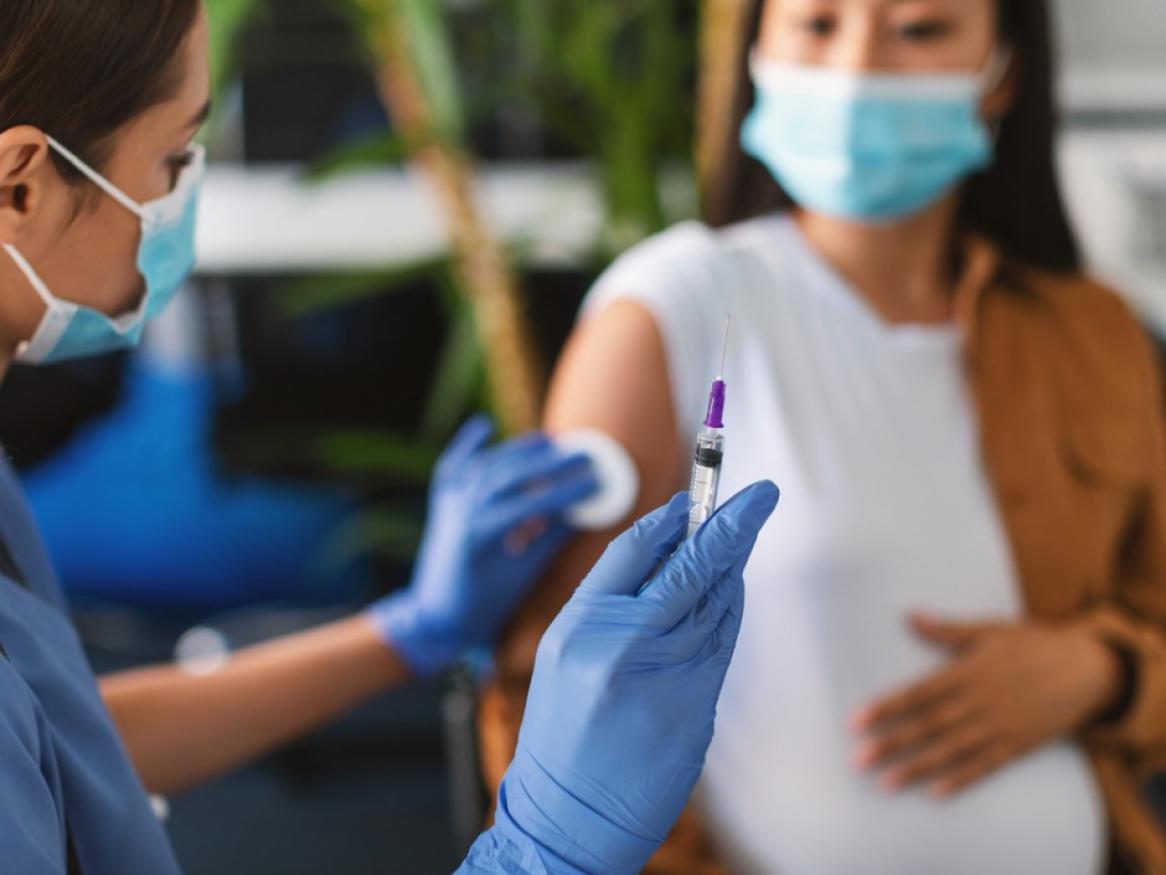 Pregnant woman receiving a vaccination