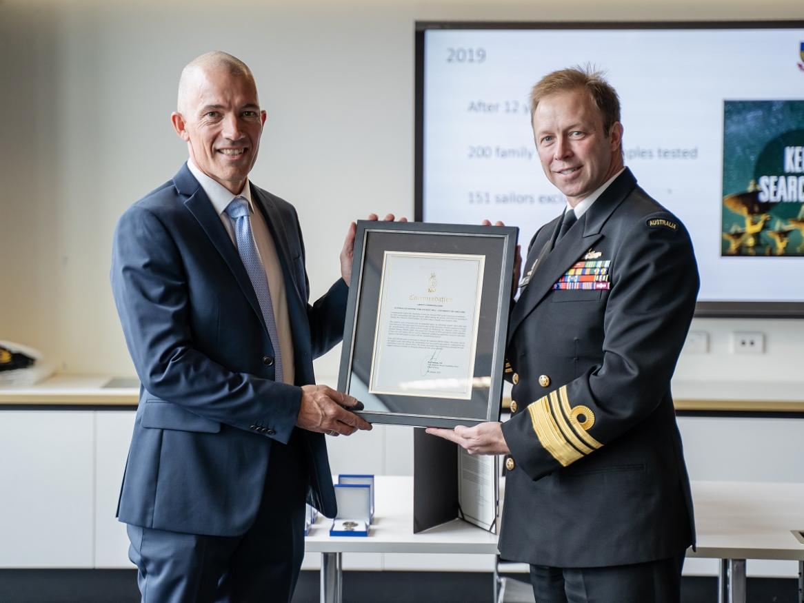 The University of Adelaide’s Associate Professor Jeremy Austin accepts the commendation from Vice Admiral Noonan.