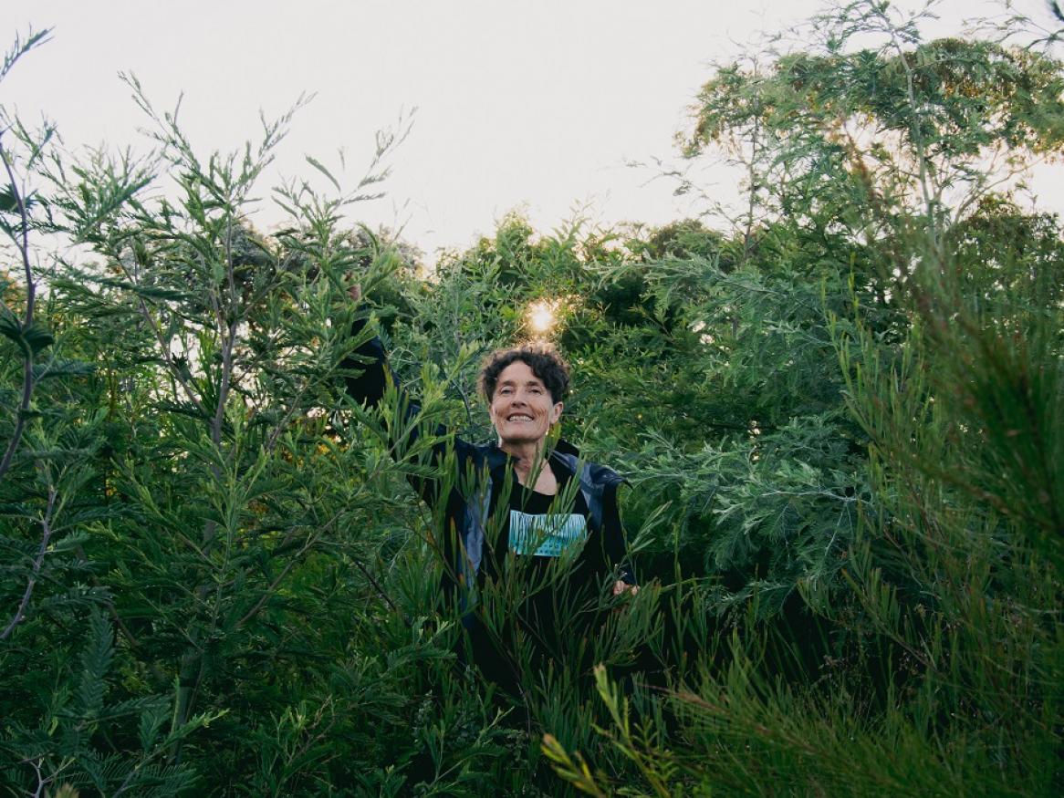 Edwina Robinson smiles amongst a mini forest in Canberra.