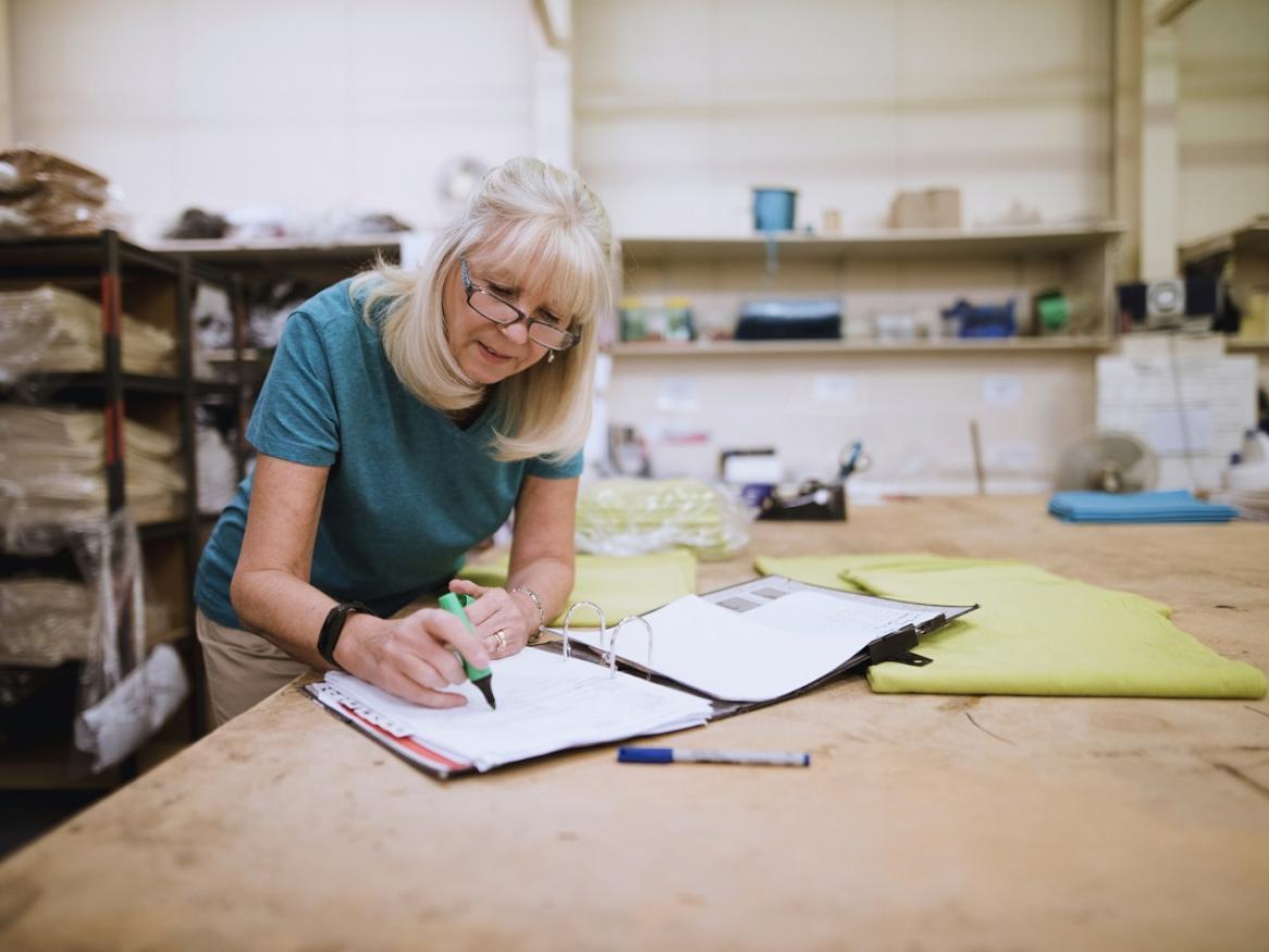 A female pensioner working in an office.