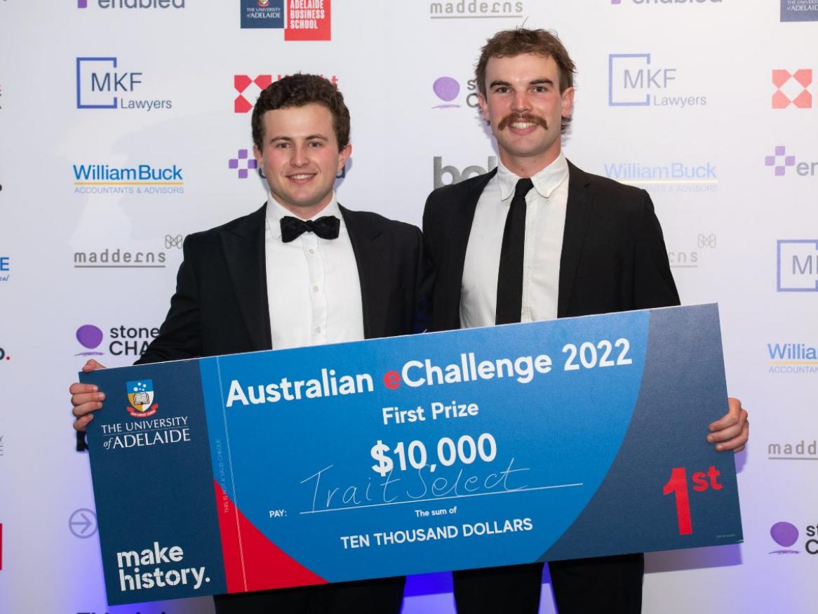 Hector and Tom smile and hold their $10,000 cheque for winning the eChallenge.