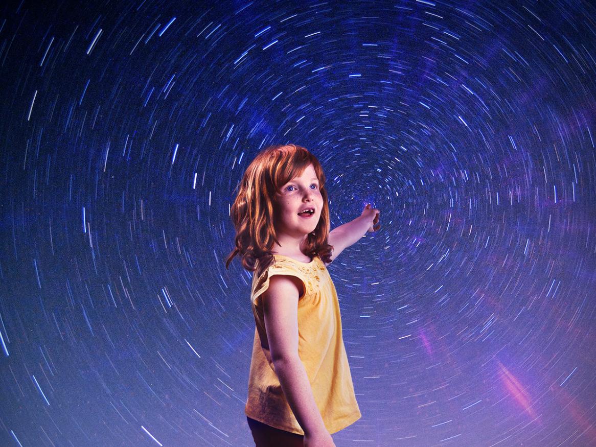 A child standing in front of a starry sky