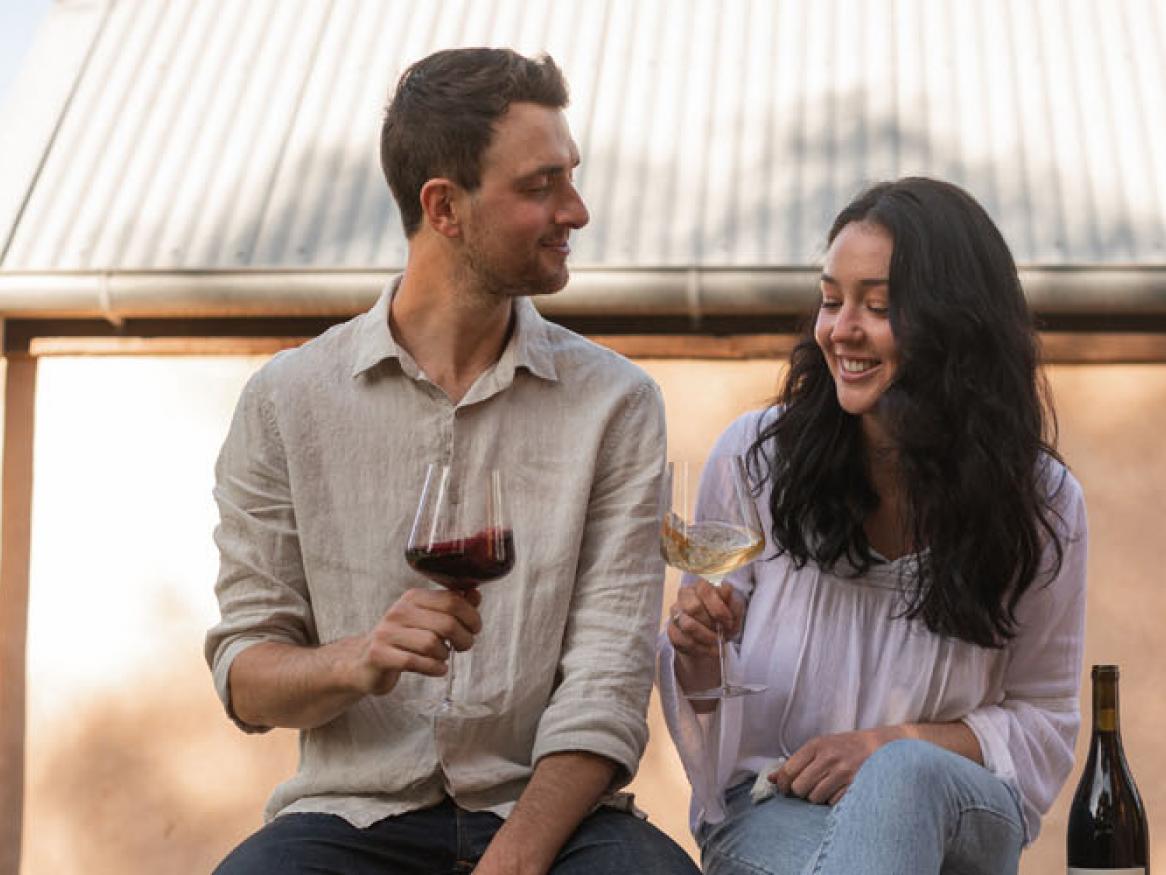 Two people holding wine glasses