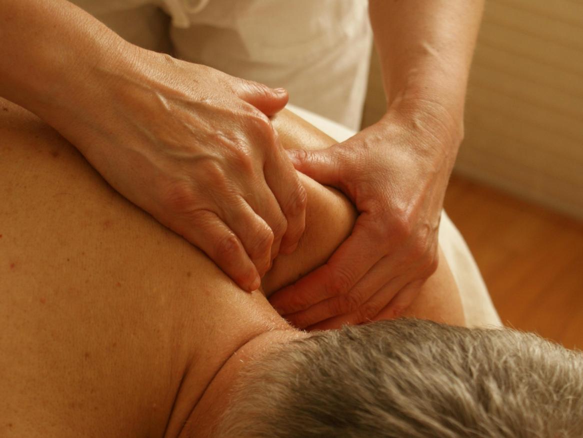 A man receives a shoulder massage